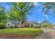 Charming single-story home with a beautiful lawn, porte-cochere, and inviting curb appeal at 877 Honey Creek Rd, Mcdonough, GA 30252