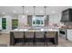 Bright kitchen featuring a center island with seating, modern appliances, and brick backsplash at 877 Honey Creek Rd, Mcdonough, GA 30252