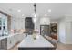 Bright kitchen with stainless steel appliances, brick backsplash, and center island at 877 Honey Creek Rd, Mcdonough, GA 30252