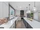 Modern kitchen with white cabinets, stainless appliances, brick backsplash, and center island at 877 Honey Creek Rd, Mcdonough, GA 30252