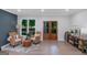 Cozy living room features two wicker chairs, hardwood floors, and a view of the outside at 877 Honey Creek Rd, Mcdonough, GA 30252