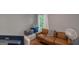 A cozy living room shows a comfortable leather couch and a glimpse of outdoor greenery at 877 Honey Creek Rd, Mcdonough, GA 30252