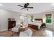 Bright main bedroom with a ceiling fan, a bathroom and natural light from the large window at 877 Honey Creek Rd, Mcdonough, GA 30252