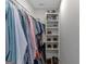 Walk-in closet with shelves for shoe storage and clothing racks at 877 Honey Creek Rd, Mcdonough, GA 30252