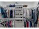 Organized walk-in closet with shelving and hanging rods for clothes and shoes at 877 Honey Creek Rd, Mcdonough, GA 30252