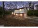 Charming two-story home with a brick and siding exterior and well-lit windows at dusk at 40 Derby Country Dr, Ellenwood, GA 30294