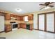Well-lit kitchen with wood cabinets, modern appliances, and access to the backyard at 40 Derby Country Dr, Ellenwood, GA 30294
