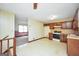 Traditional eat-in kitchen features wood cabinets and vintage-style flooring and wallpaper at 40 Derby Country Dr, Ellenwood, GA 30294
