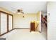 Open floor plan with door to the outside and entry to a downstairs stairway at 40 Derby Country Dr, Ellenwood, GA 30294