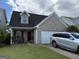 Charming single-Gathering home with brick and siding, features a well-maintained front yard and attached garage at 2075 Tussahaw Xing, Mcdonough, GA 30252