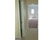 Bright hallway featuring neutral walls and tiled flooring that leads to a carpeted room at 2075 Tussahaw Xing, Mcdonough, GA 30252