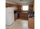 Functional kitchen featuring wood cabinets, a window over the sink, and appliances at 2075 Tussahaw Xing, Mcdonough, GA 30252
