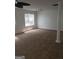 Spacious living room featuring neutral walls, a ceiling fan, and a large window at 2075 Tussahaw Xing, Mcdonough, GA 30252