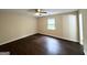 Bedroom featuring hardwood floors, a ceiling fan, and a bright window at 25 Stoneway Dr, Villa Rica, GA 30180