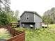 View of the exterior of the home showing the back deck and wooded lot at 25 Stoneway Dr, Villa Rica, GA 30180