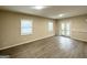 Spacious living room with new flooring, two windows, and an entry door at 25 Stoneway Dr, Villa Rica, GA 30180