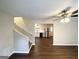 Open-concept living room with hardwood floors, ceiling fan, and view of the kitchen at 25 Stoneway Dr, Villa Rica, GA 30180