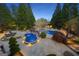Aerial view of a stunning pool and hot tub, surrounded by manicured landscaping and stone patio at 113 Regents Sq, Peachtree City, GA 30269