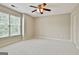 Neutral bedroom with a ceiling fan and bright natural light through a large window at 113 Regents Sq, Peachtree City, GA 30269