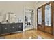 Bright foyer with hardwood floors, detailed doors, a modern mirror, and a view of the rest of the home at 113 Regents Sq, Peachtree City, GA 30269