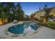 Inviting pool with stone patio, manicured landscaping, and cozy daybed at 113 Regents Sq, Peachtree City, GA 30269
