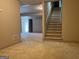Carpeted basement area with view of stairway and access to other basement areas at 232 Darwish Dr, Mcdonough, GA 30252