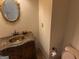 Traditional bathroom with bronze sink, dark marble countertop, and decorative gold mirror at 232 Darwish Dr, Mcdonough, GA 30252