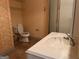 Bright bathroom with vanity and sink adjacent to commode and glass enclosed shower at 232 Darwish Dr, Mcdonough, GA 30252