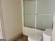 Bathroom with a frosted sliding door over a bathtub and a white toilet at 232 Darwish Dr, Mcdonough, GA 30252