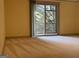 Bedroom with sliding glass doors leading to a small balcony, natural light at 232 Darwish Dr, Mcdonough, GA 30252