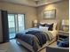 Cozy bedroom features neutral colors, a tray ceiling and sliding glass doors leading to an outdoor area at 232 Darwish Dr, Mcdonough, GA 30252