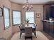 Cozy dining room featuring a modern chandelier, stylish furnishings and a large window for natural light at 232 Darwish Dr, Mcdonough, GA 30252