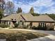 Lovely single-story brick and stone home with a well-maintained lawn and lush landscaping at 232 Darwish Dr, Mcdonough, GA 30252