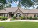 Charming single-story home with a stone and brick facade, a well-manicured lawn, and lush landscaping at 232 Darwish Dr, Mcdonough, GA 30252