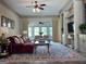 Inviting living room featuring a ceiling fan, ample seating, and large windows, perfect for relaxation and entertaining at 232 Darwish Dr, Mcdonough, GA 30252