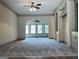 Open living room with built-ins and a view to the bright sunroom at 232 Darwish Dr, Mcdonough, GA 30252
