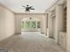 Spacious living room with built-in cabinets and a view into the sunroom with large windows at 232 Darwish Dr, Mcdonough, GA 30252