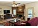 Comfortable living room featuring a brick fireplace, plush seating, and a ceiling fan for a relaxing ambiance at 232 Darwish Dr, Mcdonough, GA 30252