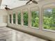 Bright sunroom with ceiling fans and multiple windows offering serene outdoor views at 232 Darwish Dr, Mcdonough, GA 30252