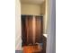 Bathroom featuring a shower with curtain, toilet, and vanity with orange rugs on a wood floor at 11909 Lovejoy Crossing Blvd, Hampton, GA 30228