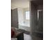 Well-lit bathroom featuring a soaking tub and separate glass-enclosed shower at 11909 Lovejoy Crossing Blvd, Hampton, GA 30228