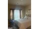 Bedroom featuring a cozy bed, curtains, and natural light coming through the windows at 11909 Lovejoy Crossing Blvd, Hampton, GA 30228