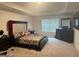 Spacious main bedroom with a large bed, dresser, and recessed ceilings at 11909 Lovejoy Crossing Blvd, Hampton, GA 30228