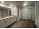 Modern bathroom featuring double vanity with granite countertop, and wood look flooring at 30 Yellow Brick Way # 3, Covington, GA 30014