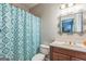 Cozy bathroom features a wood vanity and patterned shower curtain, offering a functional and practical space at 2693 Blairsden Nw Pl, Kennesaw, GA 30144