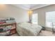 Cozy bedroom with neutral walls, plush carpet, and a sun-filled window for a comfortable living space at 2693 Blairsden Nw Pl, Kennesaw, GA 30144