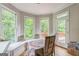 Sunlit breakfast nook surrounded by windows, complete with a built-in bench and backyard access at 2693 Blairsden Nw Pl, Kennesaw, GA 30144