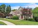 Charming two-story home boasts a stone and stucco facade, complemented by manicured landscaping and a lush green lawn at 2693 Blairsden Nw Pl, Kennesaw, GA 30144