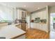 Traditional-style kitchen features white cabinets, hardwood floors, stainless steel appliances, and plenty of counter space at 2693 Blairsden Nw Pl, Kennesaw, GA 30144