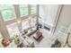 An aerial view of the bright living room with a fireplace, cathedral ceilings, and backyard views at 2693 Blairsden Nw Pl, Kennesaw, GA 30144